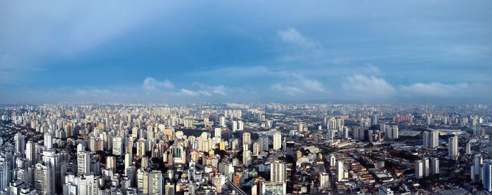 Aerial view of modern buildings in city against sky