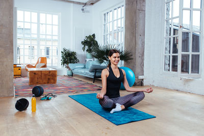 Young woman exercising at home