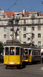 Cable cars against building in city
