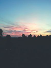 Silhouette landscape against scenic sky