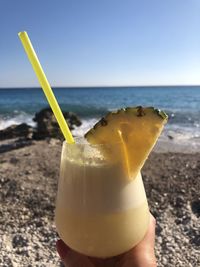 Close-up of drink on the beach