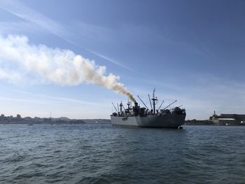 Ship sailing in sea against sky