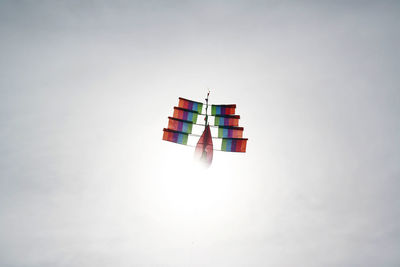 Low angle view of flags hanging against sky