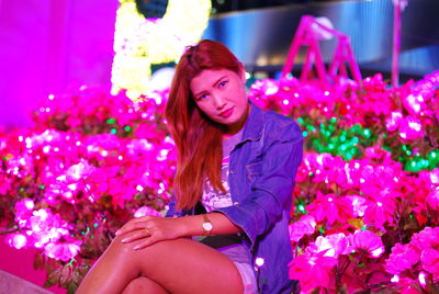 Portrait of beautiful woman sitting on purple flower