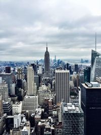 City skyline against cloudy sky