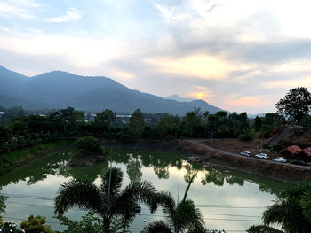 Scenic view of lake by trees against sky