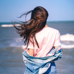 Midsection of woman standing at beach