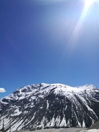 Scenic view of snowcapped mountains against clear blue sky