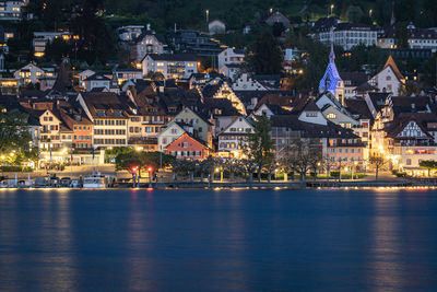 High angle view of illuminated buildings in city zug at night