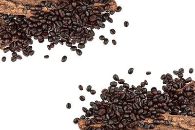 High angle view of coffee beans against white background