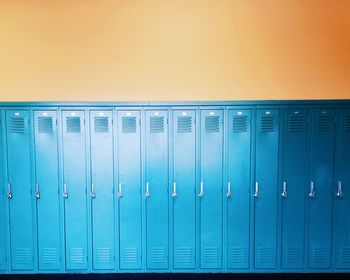 Blue lockers on an orange wall