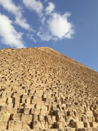 Low angle view of stone wall against sky