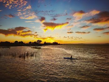 Scenic view of sea against orange sky