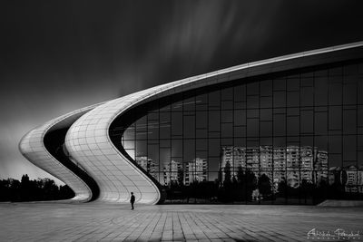 People in modern building against sky