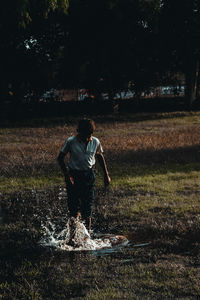 Rear view of man standing on field