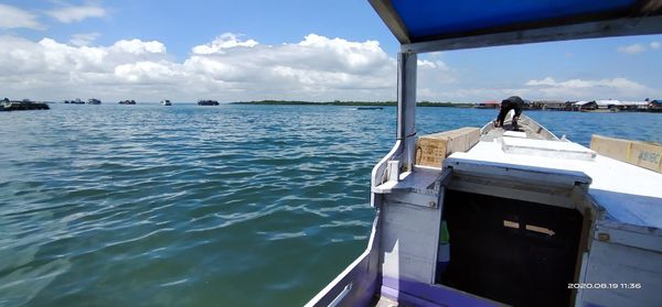 Boat sailing in sea against sky