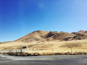 Scenic view of mountains against clear blue sky