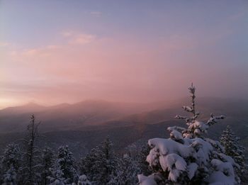 Scenic view of snow covered mountains against sky during sunset