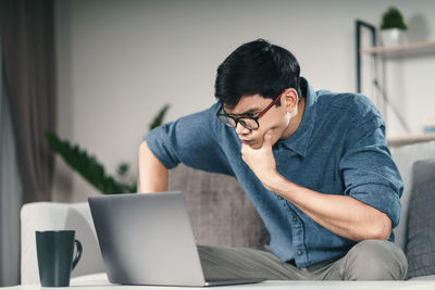 Man sitting on table at home