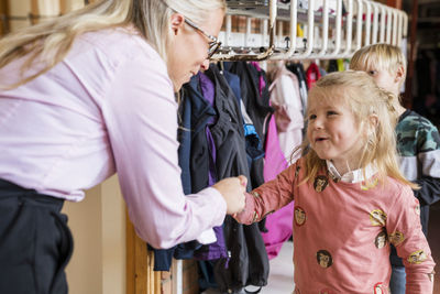 Teacher greeting children