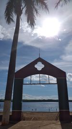 Built structure on beach against sky