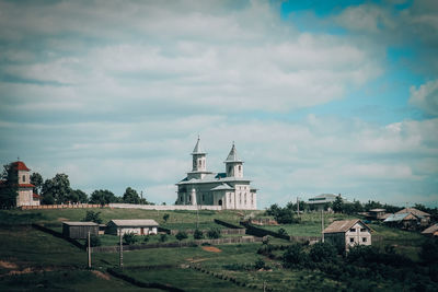 Houses and church panoramic view against sky