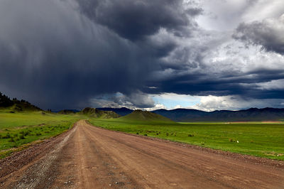 Empty road along countryside landscape