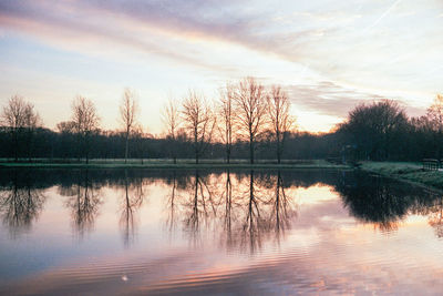 Scenic view of lake against sky at sunset