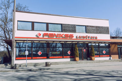 Information sign on building against blue sky