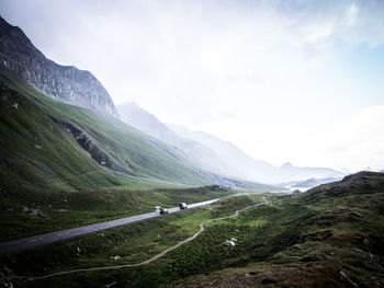 Road amidst snowcapped mountains against sky