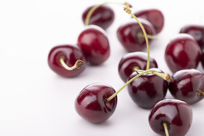 Close-up of grapes over white background