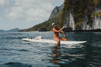 Full length of woman in sea against sky