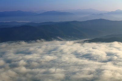 Scenic view of cloudscape mountains against sky