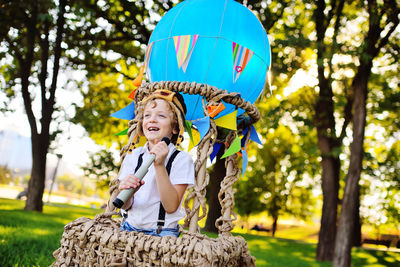 Happy boy standing in hot air balloon