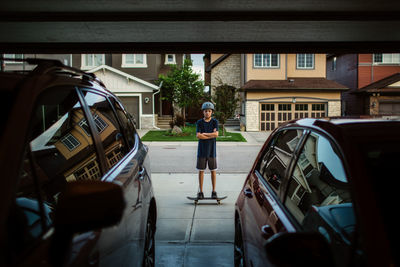 Teen boy on skateboard from garage