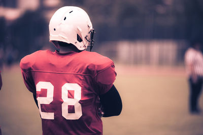 Rear view of man standing against blurred background