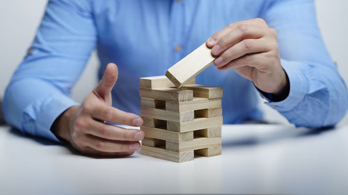 Close-up of man working on wooden table