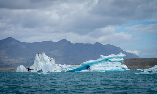 Scenic view of sea, glacier and mountains against sky