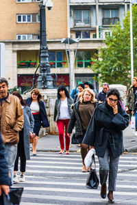 People walking on road in city