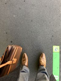 Low section of man standing on road