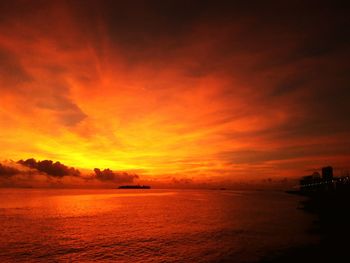 Scenic view of sea against romantic sky at sunset