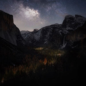 Scenic view of mountains against sky at night