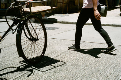 Low section of person riding bicycle on street