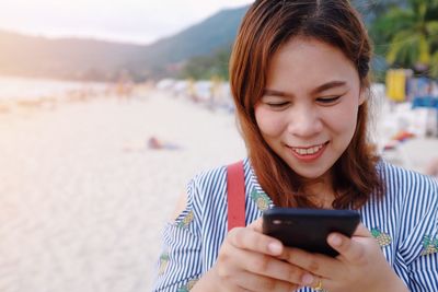 Mid adult woman using mobile phone