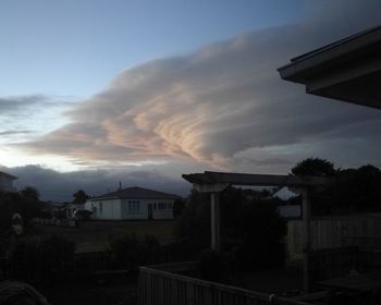 Houses against sky during sunset