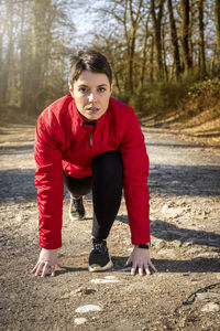Young woman is starting to run in the woods. 