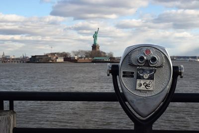 View of coin-operated binoculars against cloudy sky