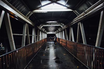 Illuminated footbridge at railroad station