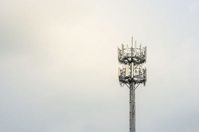 Low angle view of communications tower against sky