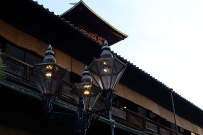 Low angle view of illuminated roof against clear sky